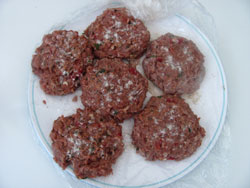 seasoned venison burgers ready for the grill
