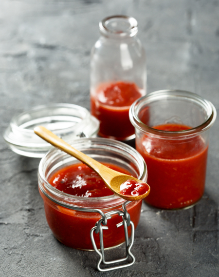 Homemade tomato ketchup being bottled up