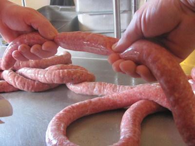 Making homemade sausages and linking them