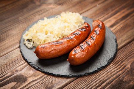 Cured bratwurst sausage served with sauerkraut