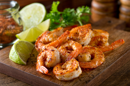 Cajun barbecue shrimps garnished with fresh lime