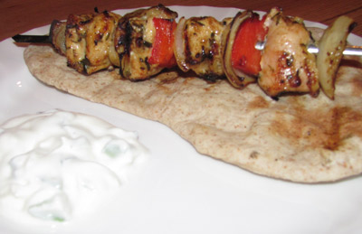 Grilled Chicken Shish Kebab Served On A Freshly Made Chapati With A Cucumber Raita Side