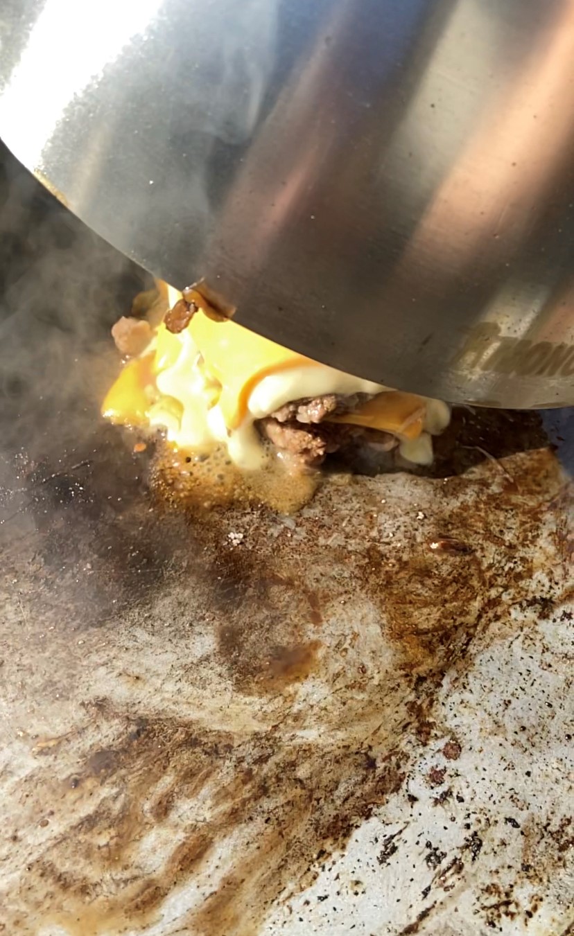 Steaming a smash burger under the Cloche