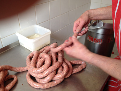 Homemade venison sausage being stuffed into hog casings
