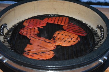 Red peppers grilling on the Monolith kamado with plancha