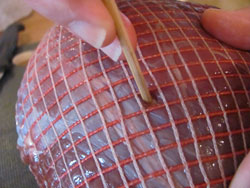 Use the base of a bamboo skewer to insert garlic pegs into the venison haunch