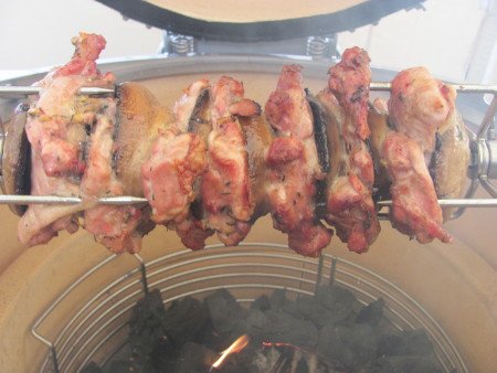 Chicken thigh and field mushrooms on the rotisserie spit roast